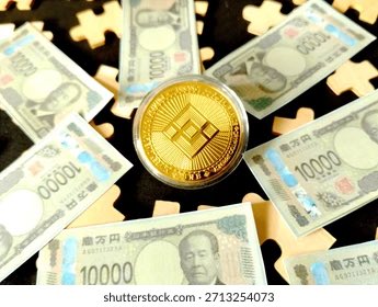 A gold Bitcoin coin displayed on top of Japanese 10,000 yen banknotes and puzzle pieces.