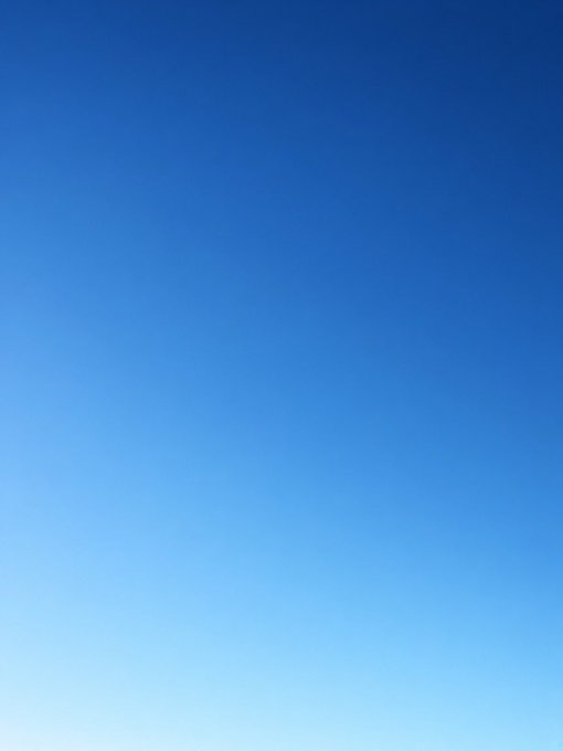 A simple gradient image transitioning from dark blue at the top to light blue at the bottom, resembling a clear sky.
