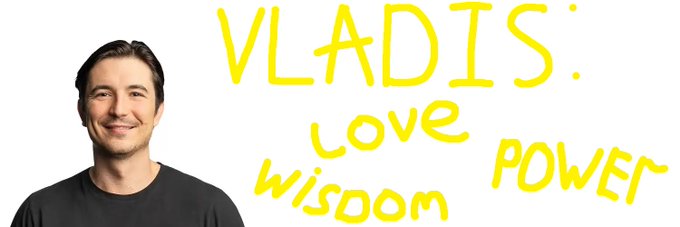 A smiling man wearing a black shirt stands next to handwritten yellow text reading 'VLADIS: LOVE WISDOM POWER'.
