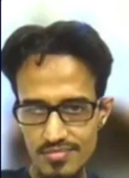 A low-resolution webcam photo of a man with glasses and dark hair, the source image for the 'Sad Minecraft Steve' meme.