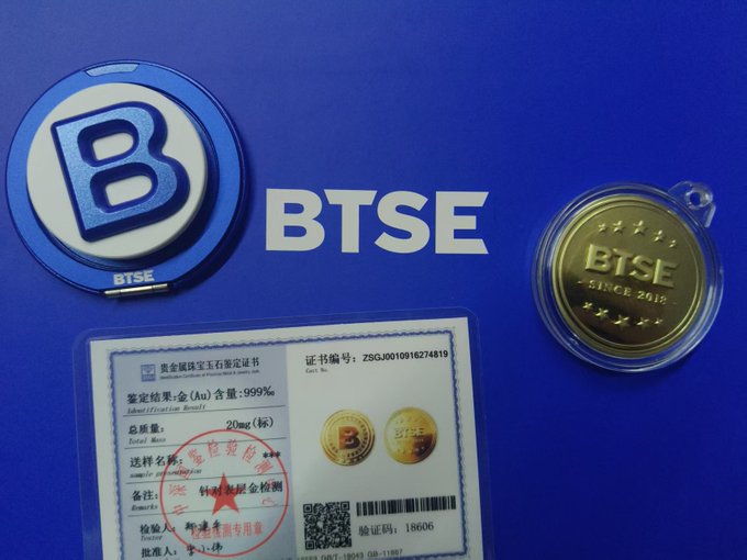 A collection of BTSE (Bermuda Stock Exchange) memorabilia including a blue BTSE logo badge, a gold BTSE coin marked 'SINCE 2012', and an authenticity certificate.
