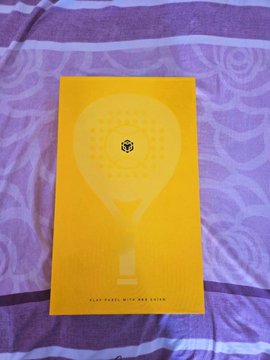 A yellow booklet lies on a purple patterned bedspread, featuring a pale light-bulb graphic with a small Bee & Flower logo and the text “PLAN AHEAD WITH BEE & FLOWER.”