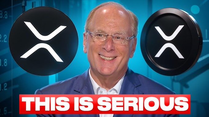 A man in glasses and a blue suit smiling against a blue background, flanked by two large XRP cryptocurrency logos, with the bold red and white text 'THIS IS SERIOUS' displayed at the bottom.