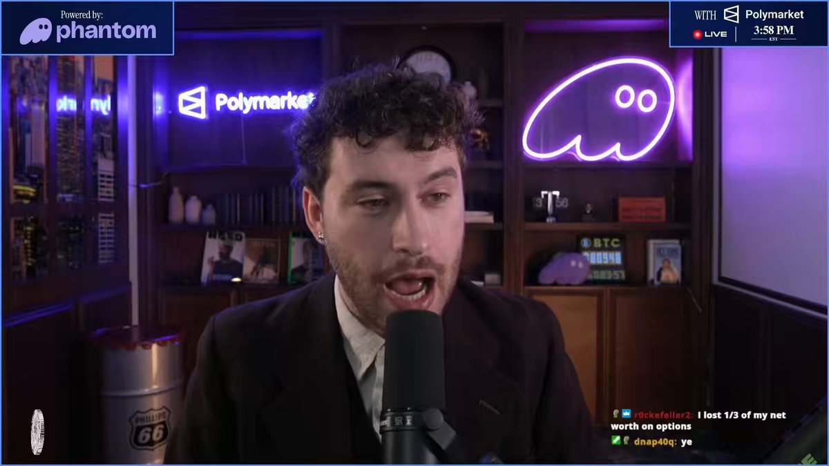 The image shows a man wearing a suit talking into a microphone in front of a computer screen, possibly during an online meeting or podcast recording session. The content displayed on the screen suggests that they are discussing trading options for Hyperliquid, with the man expressing his thoughts and opinions about them.