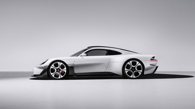 A sleek white sports car shown in profile view against a minimalist gray studio background, featuring a low-slung aerodynamic body with distinctive multi-spoke wheels.