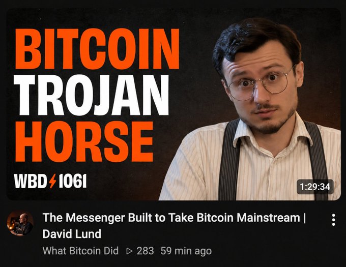A YouTube thumbnail titled 'BITCOIN TROJAN HORSE' (WBD 1061) featuring a man in glasses and suspenders, advertising an episode called 'The Messenger Built to Take Bitcoin Mainstream | David Lund' from What Bitcoin Did.