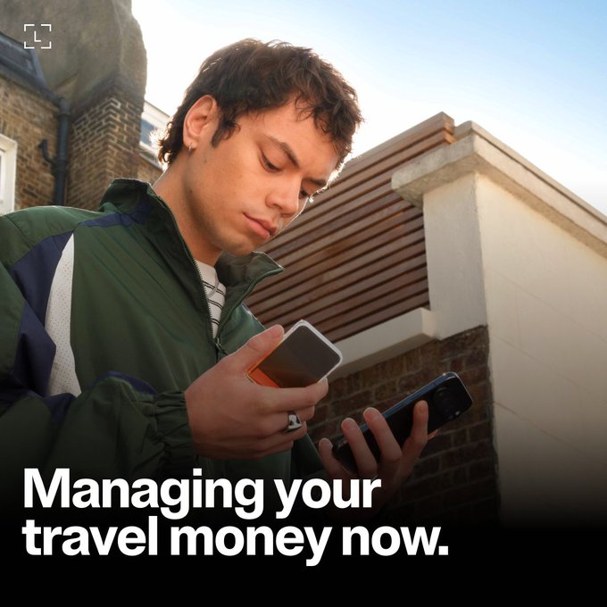 A young man is shown managing his travel money on two smartphones, illustrating the concept of true ownership and control as described in the accompanying post. The text "Managing your travel money now." is also visible.