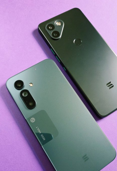 Two smartphones displayed on a purple background - a dark teal/black device with a dual camera setup and a lighter teal device with a triple camera array.