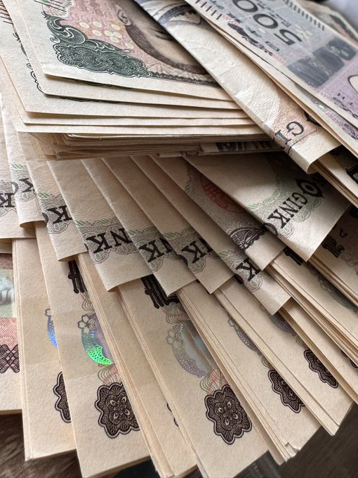 A stack of cash fanned out in preparation for purchasing XRP (Ripple) cryptocurrency. The image visually reinforces the post's intent to "buy some XRP," showcasing the physical money ready to be converted into the digital asset.