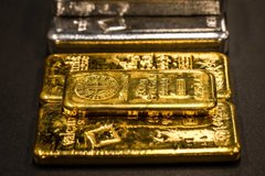 A stack of gold bars is displayed beneath a glass case on a dark surface. The image accompanies a post listing black market exchange rates and gold prices in Vietnamese Dong and USDT, highlighting the high value of gold in Vietnam.