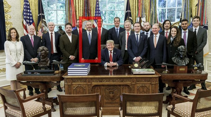 The image, highlighted by a red box, shows a group photo taken in the Oval Office featuring President Donald Trump seated at the Resolute Desk alongside approximately 15 other individuals. The person circled in red appears to be Brad Garlinghouse, the Ripple CEO, during a meeting that likely took place in connection with the 2025 XRP event mentioned in the caption.