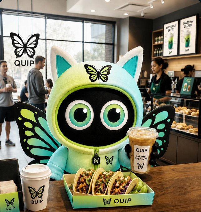 The image features a cartoon-like robot with wings sitting at a table, holding a tray of food including tacos and a drink. The scene takes place inside a coffee shop or restaurant setting where people are present around the area. There's also an advertisement for Quip network in the background that highlights how Quip is changing the way we think about computing by attaching verifiable result attestations to outcomes, creating a new standard of trust between buyers and sellers.