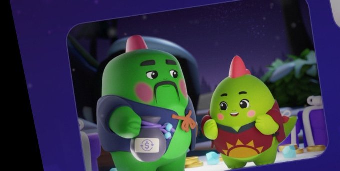 Two green, cartoonish dinosaur-like characters stand together, one appearing angry while holding a bucket and the other smiling cheerfully in a red outfit.