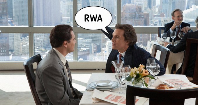 A scene from a movie showing two men in suits at a restaurant, with a speech bubble over one that says "RWA".