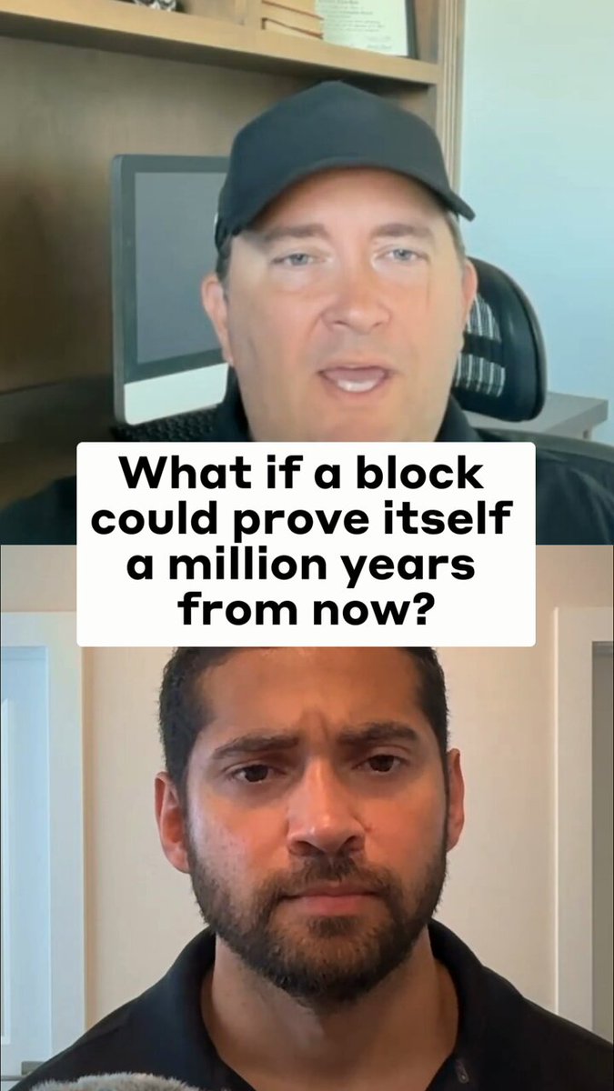 The image shows two men with beards wearing black shirts, one sitting at a desk while the other stands behind him. The man standing behind the seated man has a question about blocks and their proof. They are both looking directly at the camera.
