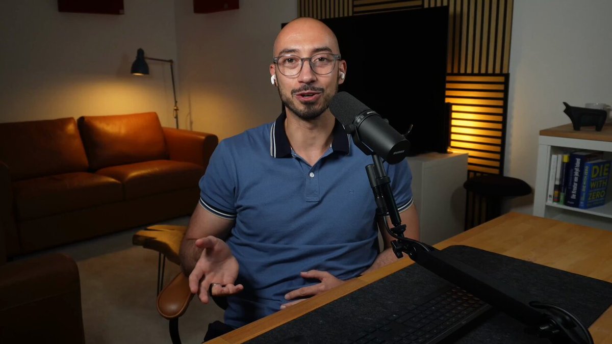 The image shows a man wearing glasses sitting at a desk with a microphone, likely recording an audio or video for a podcast or online show. The focus of the discussion is Bitcoin, as suggested by the caption provided. The man appears to be discussing the challenges associated with implementing Bitcoin in practice and how it has caused sleepless nights for many people. The image does not provide any specific information about Bitcoin itself; instead, it highlights the broader topic of Bitcoin implementation and its impact on individuals or communities.