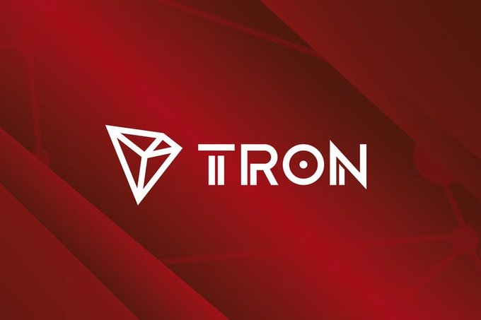 The white TRON logo and text are displayed on a dark red background with subtle geometric patterns.