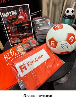 A promotional display featuring ForeGate branded merchandise including a red soccer ball, an orange shirt, and promotional cards, with the ForeGate and 'My EOWLS' logos at the bottom.