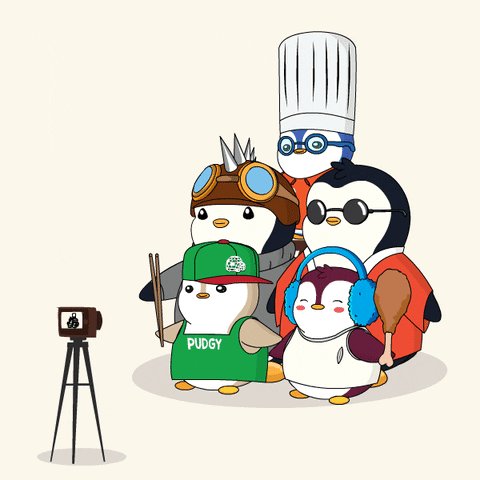 The image features a group of penguins standing next to each other, with one of them holding a camera. The penguin in the foreground has a green shirt that says "@StoopidPenguin" written on it. There are also two more penguins in the background wearing chef hats and aprons, suggesting they might be chefs or participating in some sort of cooking event. A person is taking pictures of this unique gathering using their camera. The post caption reads: "Next up is @StoopidPenguin here art work always makes me smile."