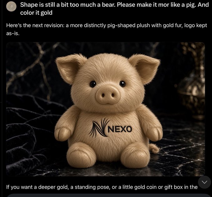A gold-colored plush pig toy with a 'NEXO' logo on its belly, displayed on a dark marble surface, shown as an AI revision responding to the request 'make it more pig-shaped and gold.'