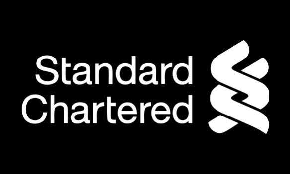 The image shows a logo for Standard Chartered Bank, which features the text "Standard Chartered" written in white against a black background. The bank logo is depicted with two lines crossing over each other to form an X shape. Below the logo, there's information suggesting that Bitcoin may have reached its bottom and possibly starting to recover near $59K. This could be because of recent market pressure or other factors affecting the value of Bitcoin.