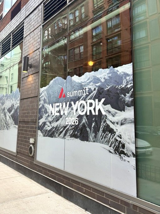 A promotional banner on a brick building announces "Summit NEW YORK 2026" with a snowy mountain backdrop, marking the start of Day 1 of the Avalanche Summit conference.