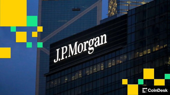The exterior of a J.P. Morgan building with the company logo visible on the glass facade, overlaid with yellow and green pixelated graphics and a CoinDesk logo in the bottom right corner.