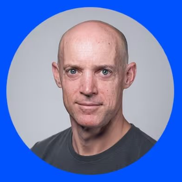 A headshot of Anthony Armstrong, a bald man wearing a dark shirt, set against a circular blue background. The image accompanies news of his appointment to Coinbase's board of directors, highlighting his background as a former Morgan Stanley banker and CFO of xAI and X.