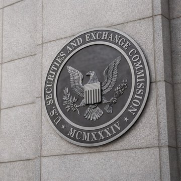 The image shows the official seal of the U.S. Securities and Exchange Commission (SEC), featuring an eagle and the founding date "MCMXXXIV" (1934), mounted on a stone wall. The seal represents the agency whose Crypto Task Force met with the Hyperliquid Policy Center, XYZ Ltd., and Sullivan & Cromwell LLP to discuss regulation for onchain perpetual markets.