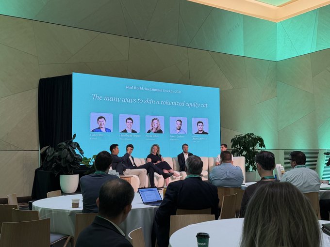 A conference panel titled 'The many ways to skin a tokenized equity' at the Real-World Asset Summit, featuring five speakers seated on stage with their headshots displayed on a large screen behind them.