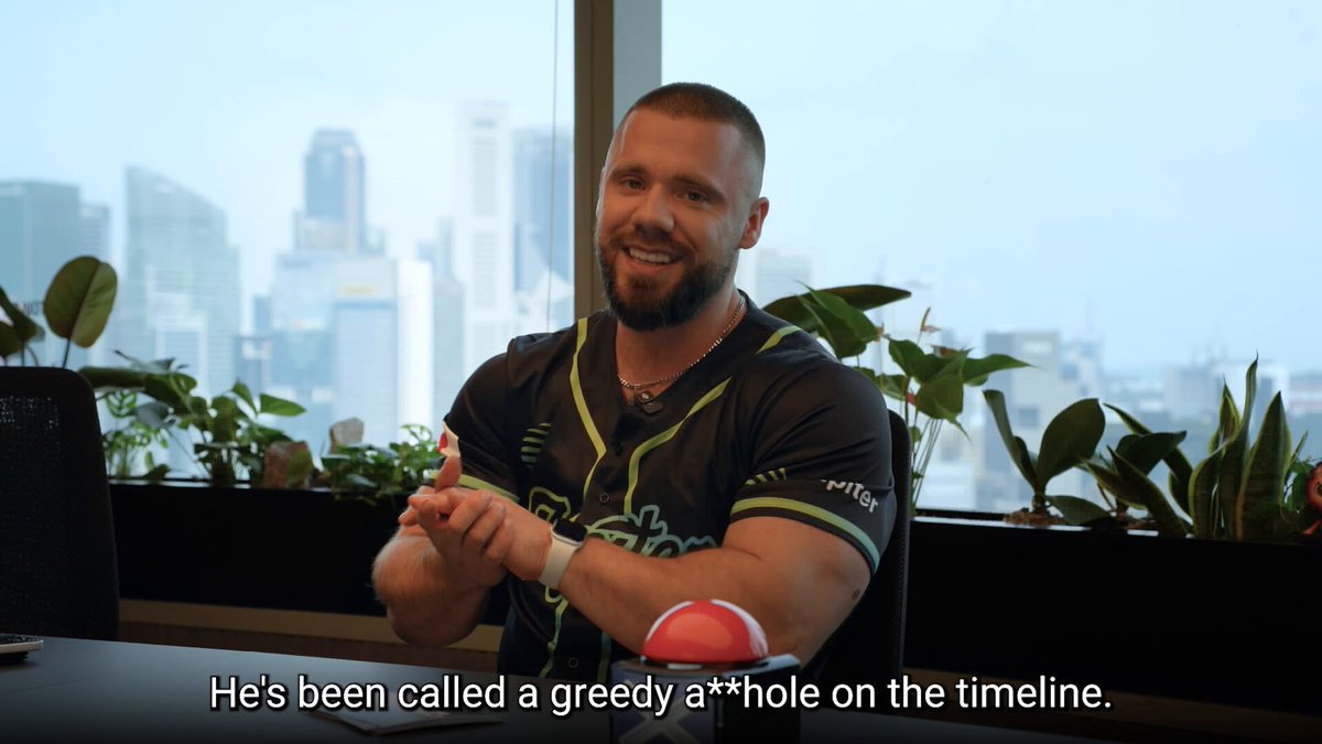 The image features a man sitting at a table with his hands on his lap while smiling for the camera. The background shows a window overlooking a city skyline, suggesting that he might be in an office or workspace located within such a setting. The caption of the image reads "JOINING THE SOLANA ECOSYSTEM CALL: @0xSoju Thursday, 
2PM UTC. Hosted by @SolBrothersPod".