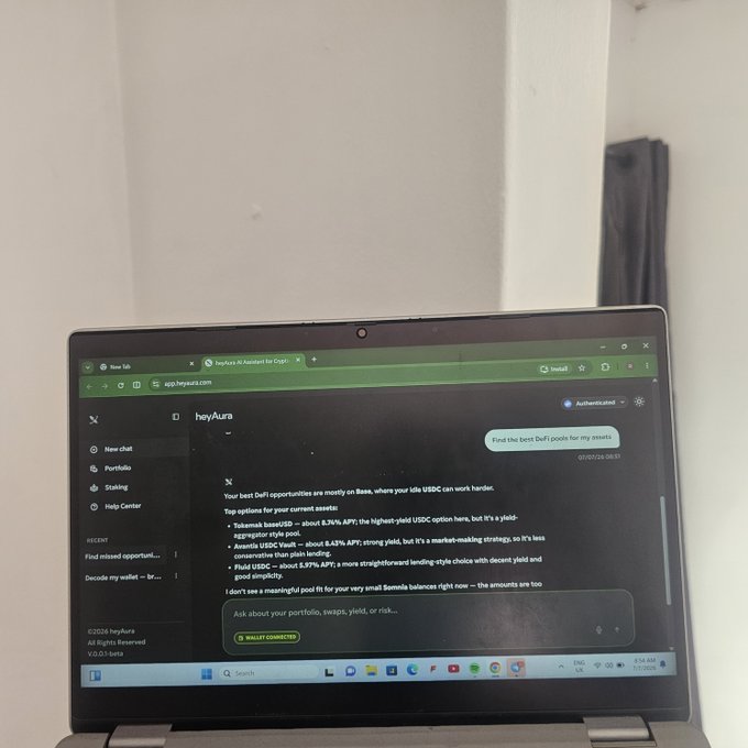 A laptop displays the heyAura AI interface answering "Find the best DeFi pools for my assets" with recommendations for Tokemak (8.26% APY), Aave's USDC Vault (8.63%), and Build USDC (5.97%), aligning with the post about using heyAura to simplify DeFi research.