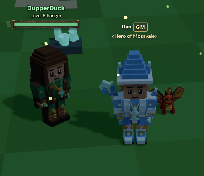 Two blocky avatars stand on a green grid floor in a voxel game world: "DupperDuck," a Level 6 Ranger in green ranger gear, and "Dan," a GM labeled <Hero of Mossvale> in blue armor with a small dragon companion. The image illustrates the Mossvale game setting referenced in the post about the $MOSS token, which serves as the in-game currency for purchasing gear, pets, mounts, and other items in the game's Auction House.