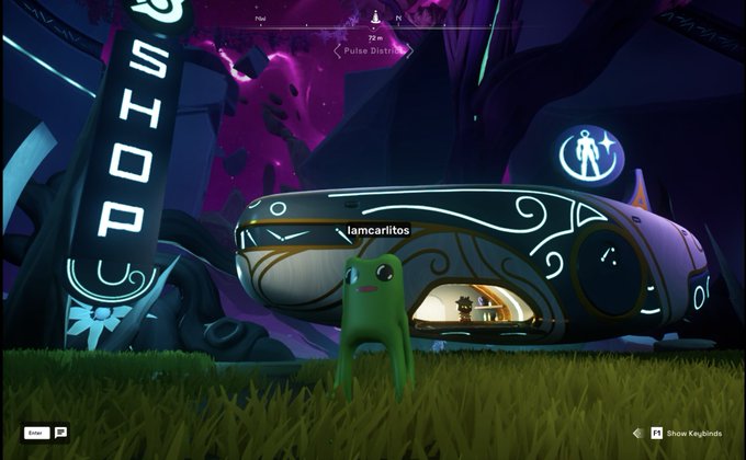 A screenshot from a video game showing a green, bipedal creature named 'lamcarritos' standing in front of a rounded building with a 'SHOP' sign on the left.