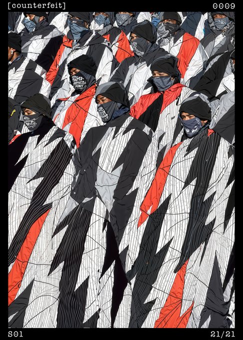 A stylized digital illustration labeled '[counterfeit]' showing multiple figures in black, white, and red hooded outfits with face masks, with 'S01' and '21/21' at the bottom.