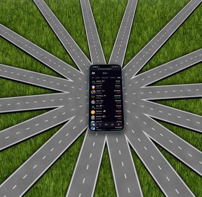 A smartphone displaying a Robinhood portfolio with various crypto tickers (ADA, SHIB, FTM, SOL, DOT, DOGE, etc.) sits at the center of a starburst pattern of asphalt roads radiating across grass, visually capturing the "all roads lead to FOMO" message as every road converges on a single screen of speculative token holdings.