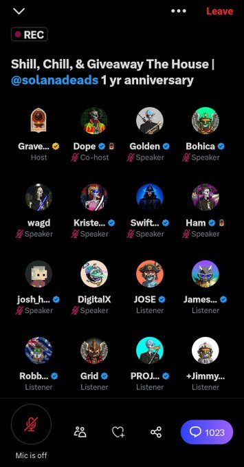 The image shows a phone screen displaying a list of people's names along with their social media handles. The text on the screen reads "Big Congratulations to the @SOLANADEADS on an outstanding one year anniversary. 1k+ in the CSession Countless memories One amazing community. The journey has been incredible, and the future looks even brighter." The phone is turned off, indicating that it's not actively being used at the moment.