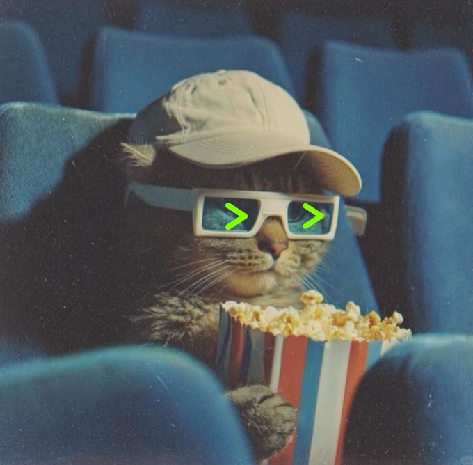 A humorous image of a tabby cat wearing a beige cap and 3D glasses, sitting in a blue theater seat while holding a striped bucket of popcorn.