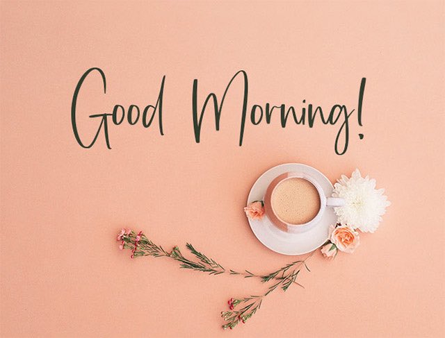 A 'Good Morning!' greeting card with elegant black script on a peach background, accompanied by a top-down photo of a coffee cup, white and pink flowers, and greenery.