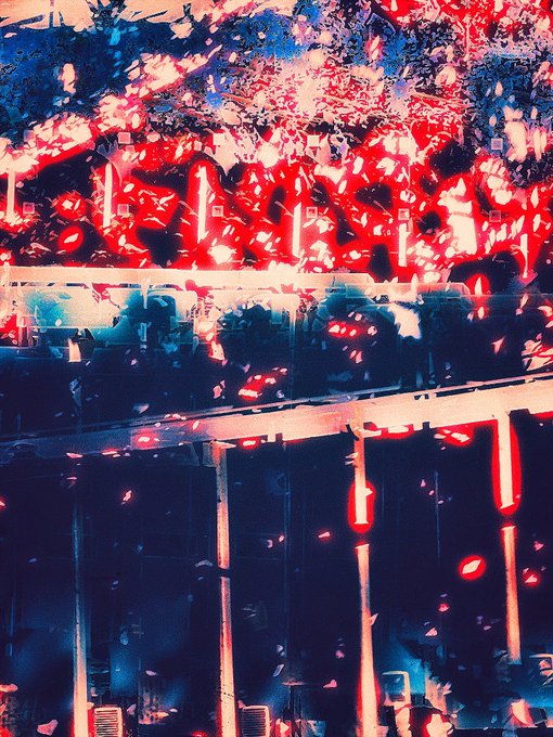 An abstract, heavily glitched image with fragmented red, pink, and dark blue shapes that appear to show a building facade or scaffolding obscured by visual distortion.