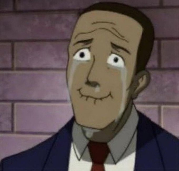 An animated man in a suit cries while forcing a smile against a brick wall background. The image humorously captures the bittersweet, forced optimism of someone trying to brag about Robinhood gains while secretly suffering rug pull losses.