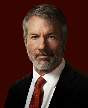 A portrait of a distinguished older man with gray hair and a beard, wearing a dark suit and red tie against a dark red background, likely depicting Michael Saylor referenced in the breaking news about Strategy's $370 million Bitcoin purchase adding 4,603 BTC to its holdings.
