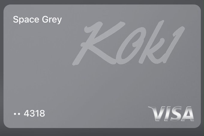 A Space Grey Visa credit card in Space Grey color with the name 'KOKI' stylized across the front and card number ending in 4318.