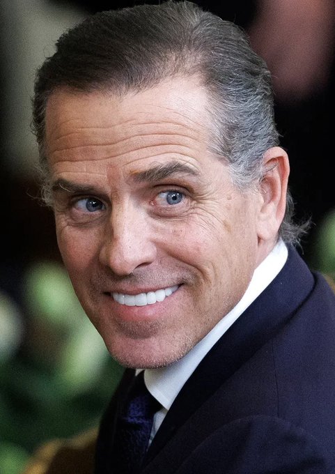 A smiling man with graying hair, blue eyes, and a dark suit appears in the image, visually unrelated to the accompanying post about Hunter Biden's "$LAPTOP" cryptocurrency token compared to the $TRUMP meme coin.