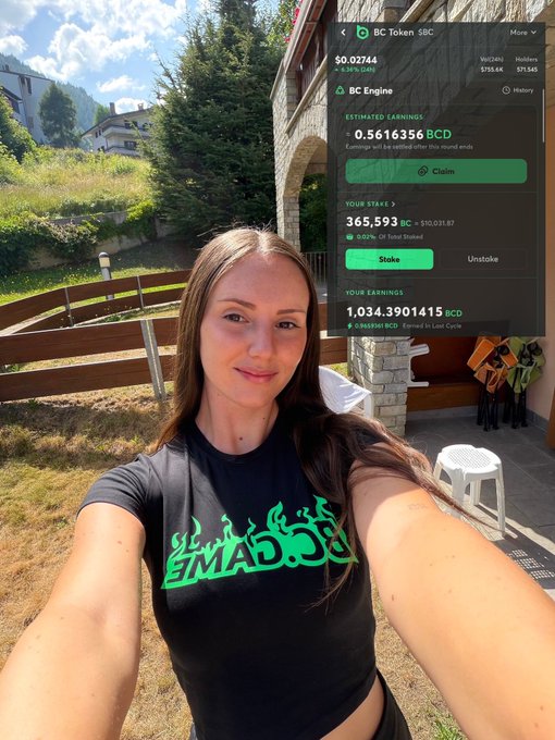 A woman wearing an 'EMAD.CC' t-shirt taking a selfie, with a BC Token SBC mining dashboard showing 365,593 BC staked and 1,034,3901415 BCD earnings overlaid.
