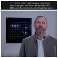 A man with a beard wearing a gray jacket appears to be presenting or speaking, with a blue grid display visible in the background. The caption overlays the image, tying into the post's reference to "ELON" and a riddle-related video clip.