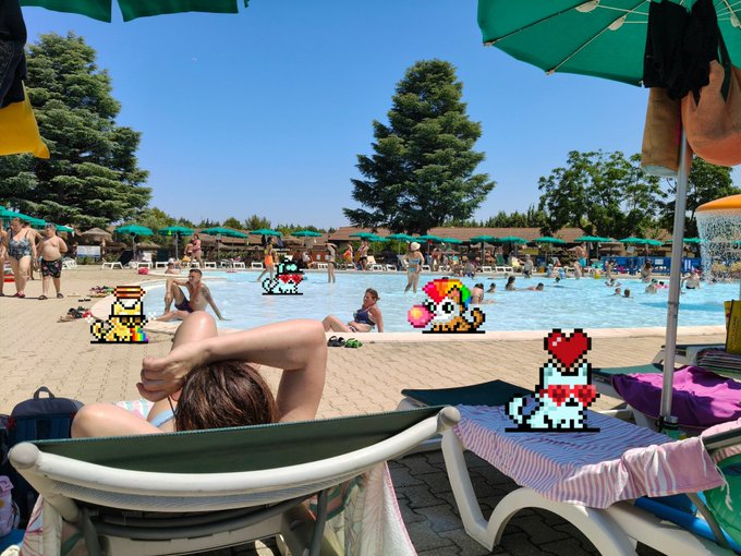 The image features a woman sitting in a chair at an outdoor pool party with several other people around her. The scene includes a large blue swimming pool, multiple umbrellas providing shade, and various beach chairs scattered throughout the area. There are also some Pokemon characters on display near the poolside. The post about the Pokemon characters is titled "The @tinyhypercats ' fp has risen significantly in recent days. Only 18 NFTs left before hitting 10 $hype". This suggests that there might be a connection between the Pokemon characters and the popularity of the pool party, possibly due to the unique theme or the presence of these characters as part of the event decorations.