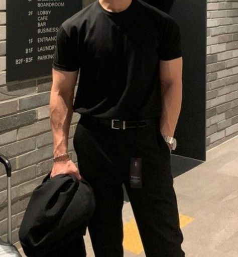The image features a man dressed in all black, standing against a brick wall with his hands in his pockets. The man's attire includes a black t-shirt, black pants, and a black jacket. There are also some words visible on the image that seem to be related to the post about blockchain networks.