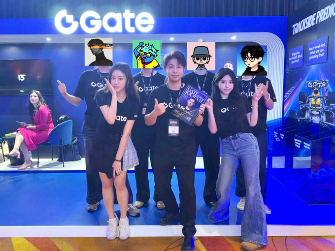 A group of staff members wearing 'Gate' t-shirts pose for a photo at the Gate.io booth, with a promotional screen reading 'TRX/USD PRICE PREDICTION' behind them.