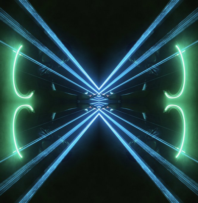 The image features a black background with blue neon lines that create an artistic, abstract design resembling a cross or a butterfly shape. The lines are arranged diagonally across the frame, creating a sense of movement and dynamism. The photo has been edited in such a way that it appears to be a reflection on a mirror, adding depth and complexity to the overall composition. The caption below the image reads "Good Morning! I can’t stop doing this kind of art I hope you like it!".